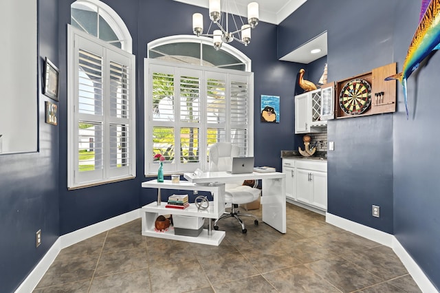 office featuring a chandelier, dark tile patterned floors, and baseboards