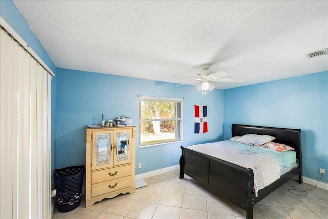 bedroom featuring light tile patterned floors, baseboards, visible vents, and a ceiling fan