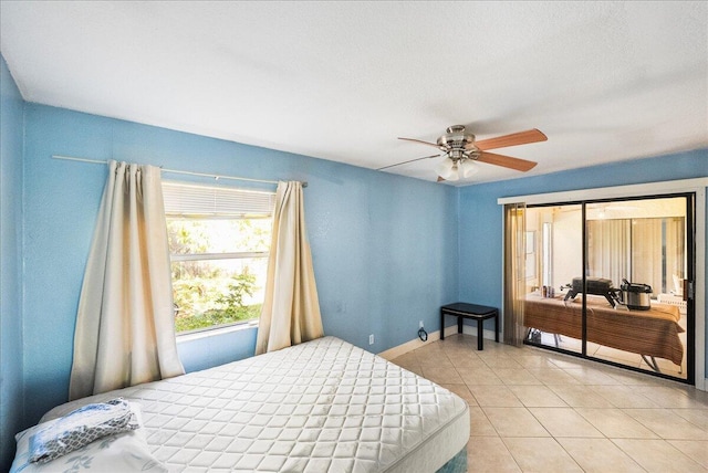 bedroom featuring ceiling fan, baseboards, and light tile patterned flooring