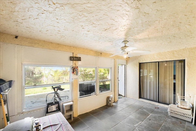 sunroom featuring ceiling fan