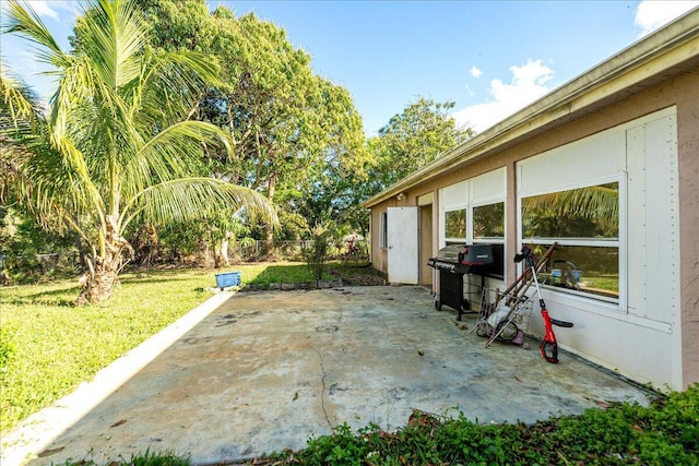 view of patio with fence and area for grilling