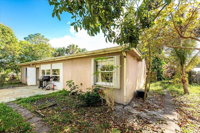 view of home's exterior featuring a patio, fence, and stucco siding