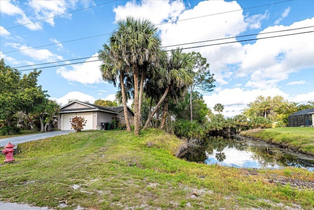 view of front of property with an attached garage, driveway, and a front yard