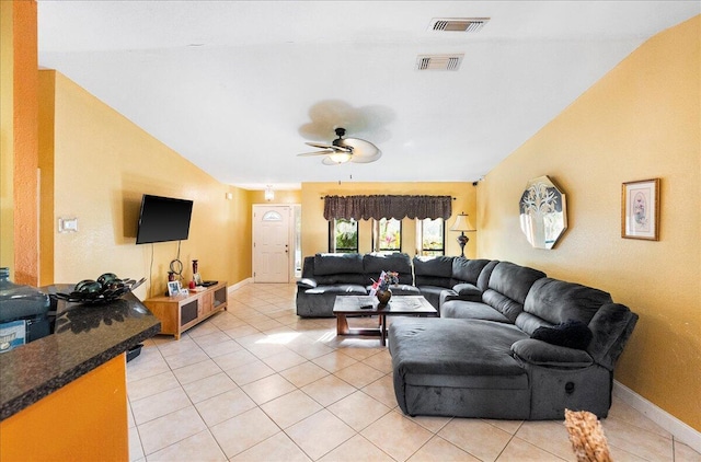 living room featuring lofted ceiling, light tile patterned floors, ceiling fan, and visible vents