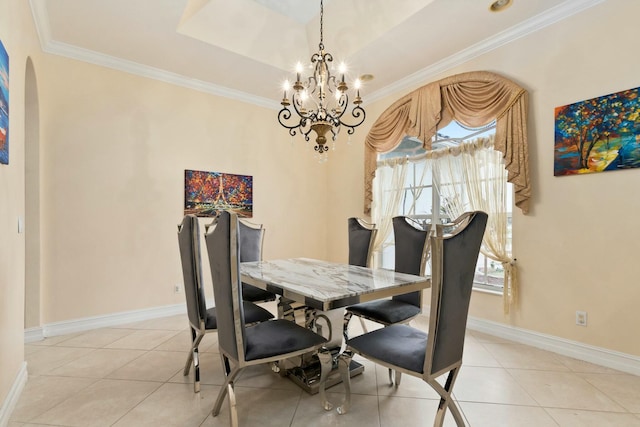 dining room featuring tile patterned floors, arched walkways, ornamental molding, and an inviting chandelier