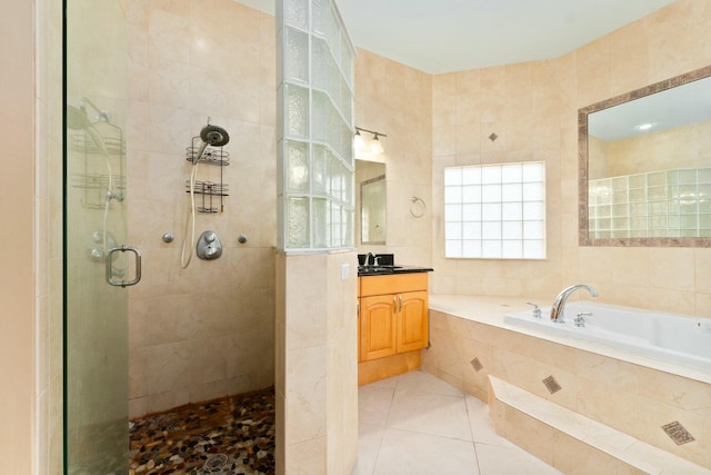 full bathroom featuring tile patterned floors, tile walls, a shower stall, a garden tub, and vanity