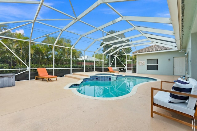 view of swimming pool with a lanai, a pool with connected hot tub, and a patio