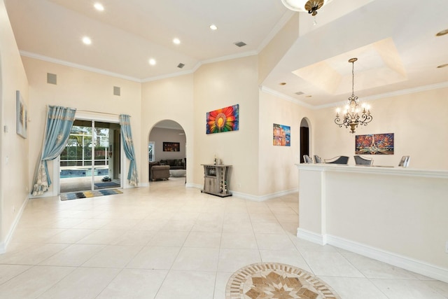 interior space featuring ornamental molding, arched walkways, light tile patterned flooring, and visible vents