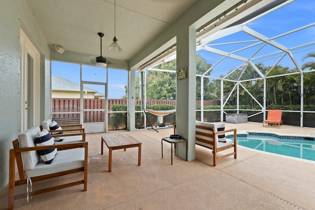 exterior space featuring fence, a patio area, a fenced in pool, and glass enclosure