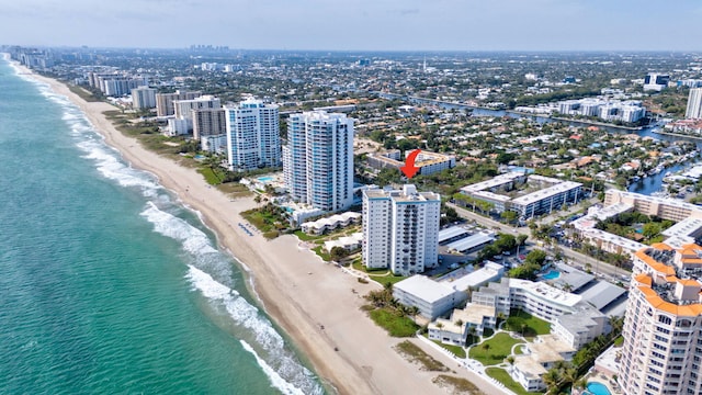 drone / aerial view with a view of the beach, a water view, and a view of city