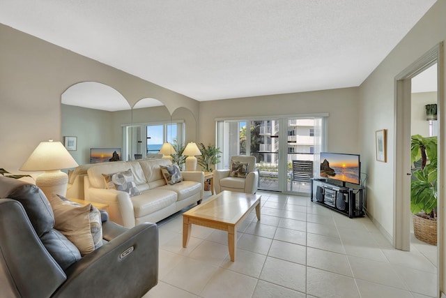 living room featuring a textured ceiling and light tile patterned flooring