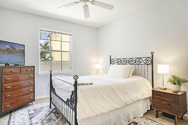 bedroom with a ceiling fan, carpet, and baseboards