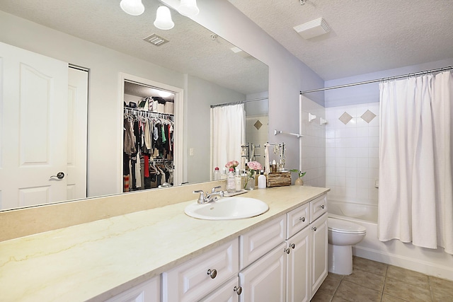 full bathroom with tile patterned flooring, shower / tub combo, vanity, visible vents, and a spacious closet