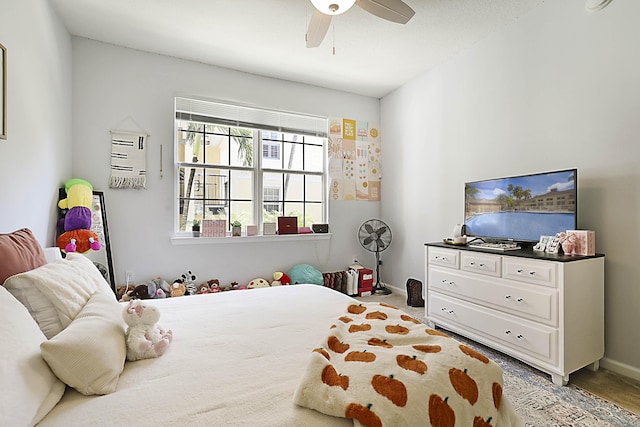 carpeted bedroom featuring a ceiling fan and baseboards