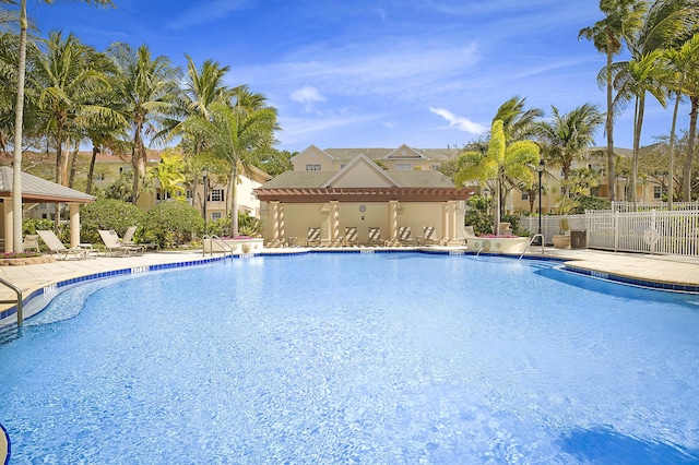 pool featuring a patio area and fence