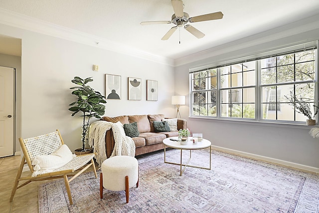 living room featuring ceiling fan, ornamental molding, and baseboards