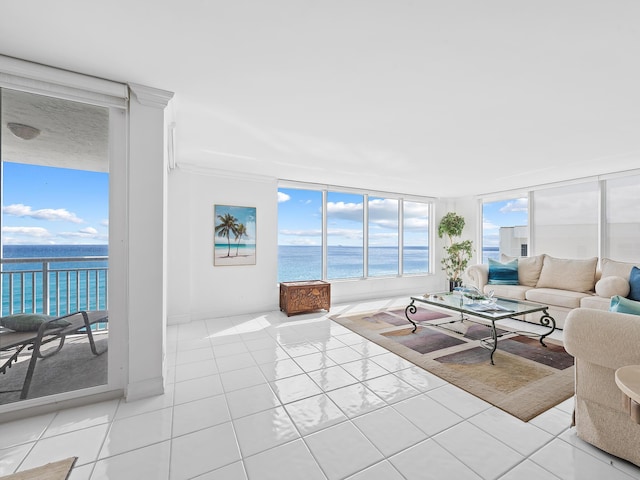 living area featuring a water view and light tile patterned floors