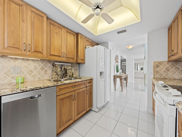 kitchen featuring white appliances, visible vents, light stone counters, a sink, and light tile patterned flooring