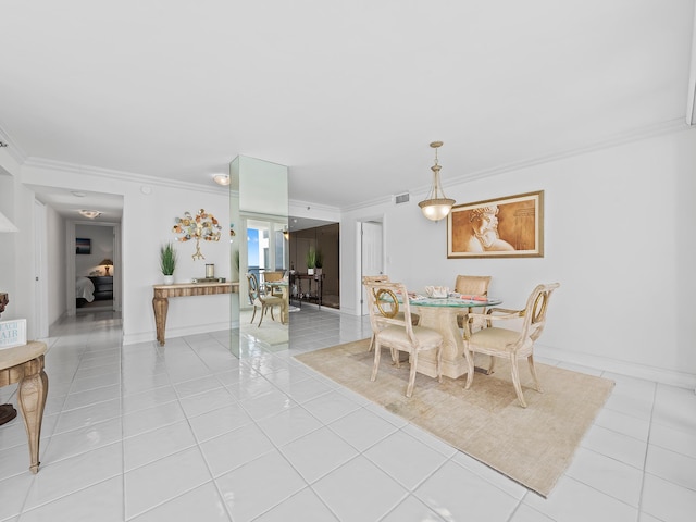 dining room featuring light tile patterned floors, baseboards, visible vents, and ornamental molding