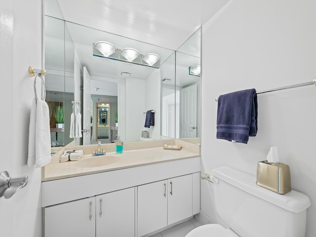 bathroom with toilet, visible vents, and vanity