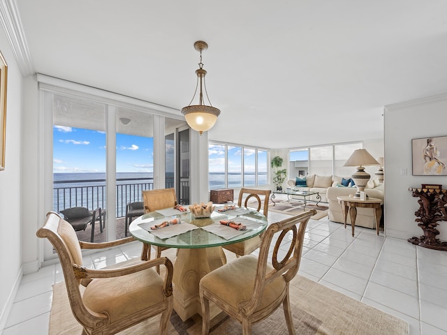 dining space with a wall of windows, a water view, and light tile patterned floors