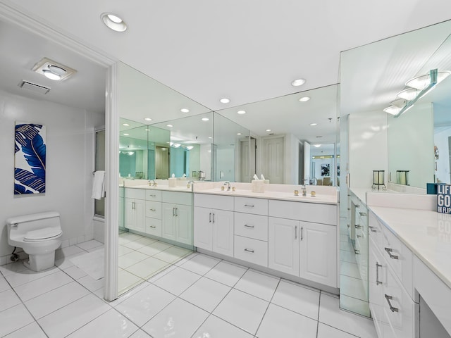 bathroom featuring recessed lighting, vanity, toilet, and tile patterned floors