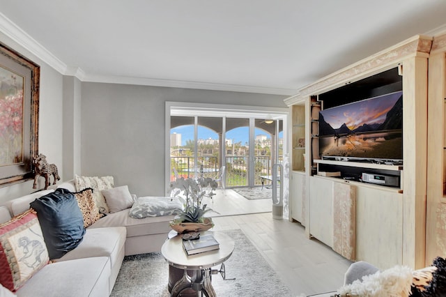 living area with ornamental molding and light wood-style floors