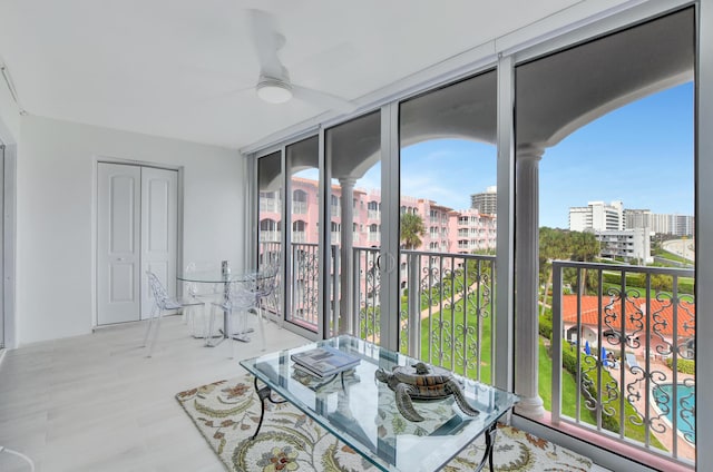 sunroom / solarium with a view of city and ceiling fan