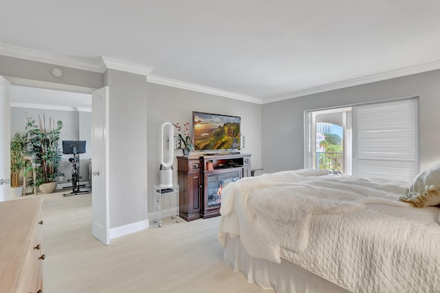 bedroom featuring ornamental molding, baseboards, and light wood finished floors