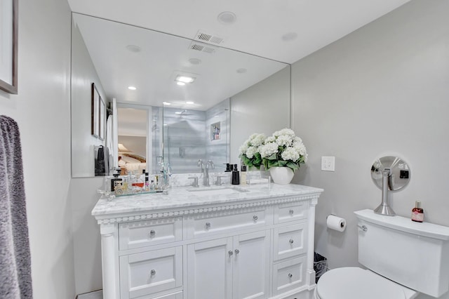 bathroom with toilet, a shower stall, visible vents, and vanity