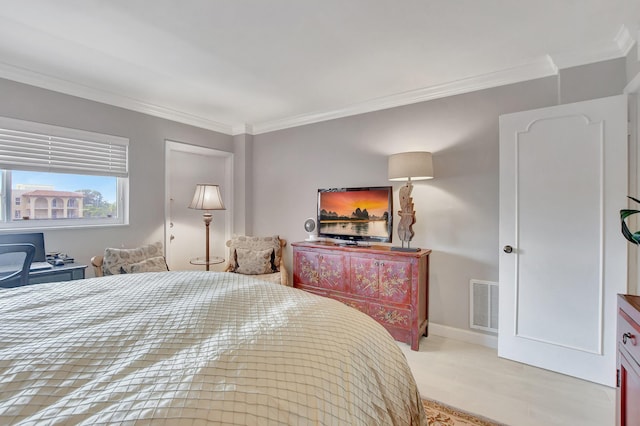 bedroom with baseboards, visible vents, and crown molding