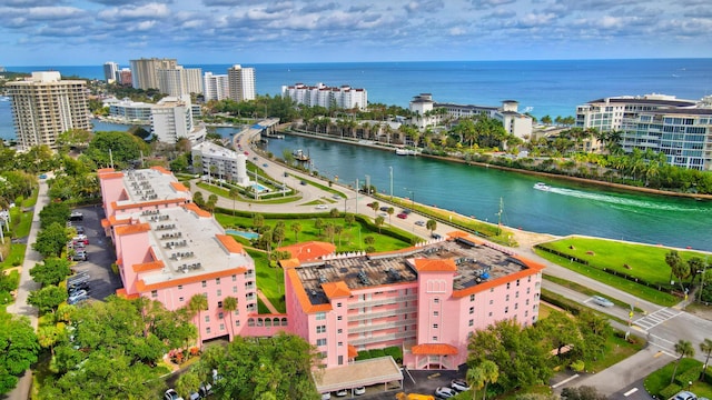 birds eye view of property with a water view and a city view