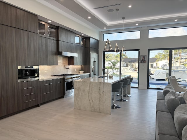 kitchen with modern cabinets, high quality appliances, and open floor plan