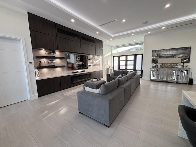 living area featuring baseboards and recessed lighting