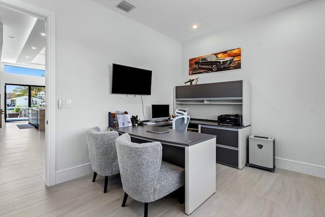 office area with recessed lighting, visible vents, light wood-style flooring, and baseboards