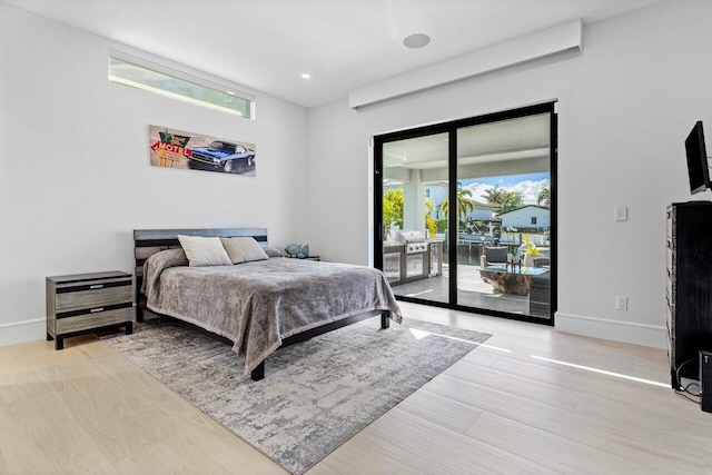 bedroom featuring access to exterior, baseboards, and recessed lighting