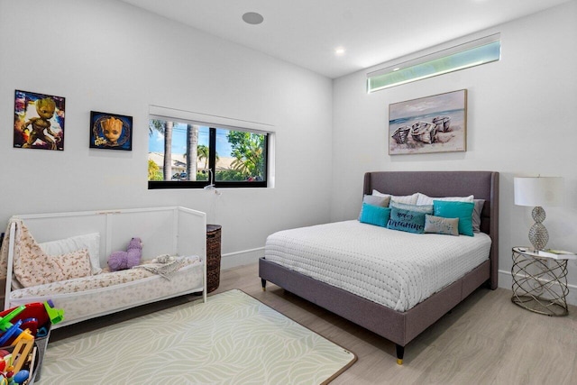 bedroom with recessed lighting, baseboards, and wood finished floors