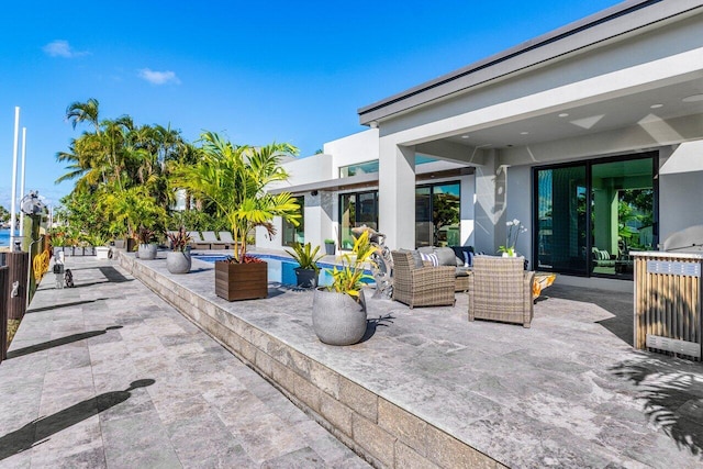 view of patio / terrace featuring an outdoor pool and outdoor lounge area