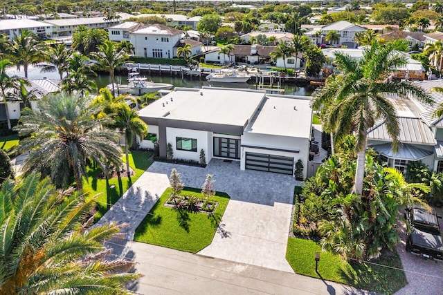 birds eye view of property with a water view and a residential view