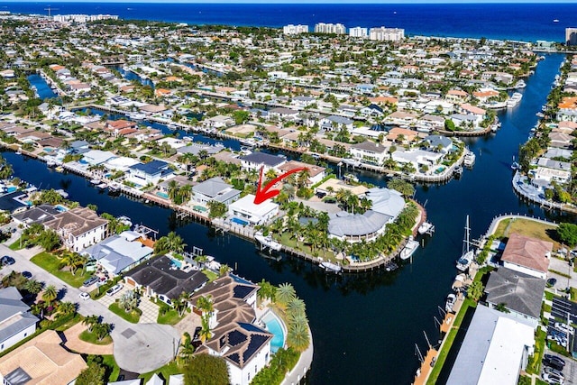 drone / aerial view with a water view and a residential view