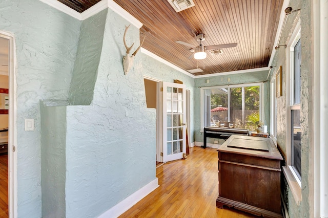 sunroom / solarium featuring wooden ceiling, visible vents, and a ceiling fan