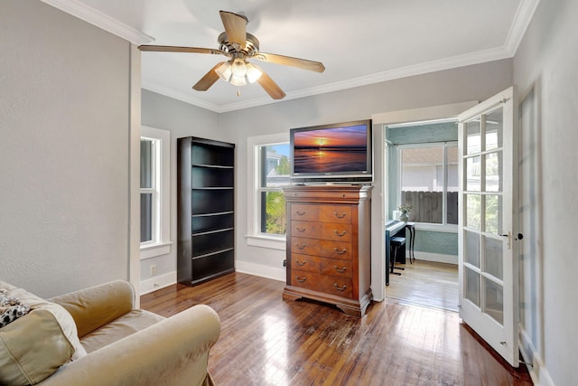 sitting room with baseboards, ceiling fan, hardwood / wood-style flooring, and crown molding