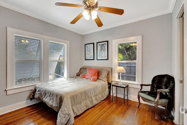 bedroom featuring ornamental molding, ceiling fan, hardwood / wood-style floors, and baseboards