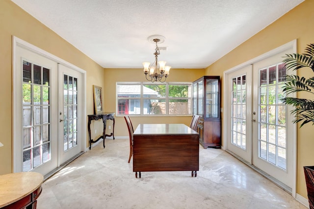 dining area featuring plenty of natural light, a chandelier, and french doors