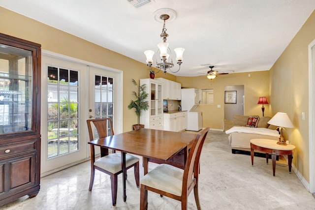 dining space featuring baseboards, ceiling fan with notable chandelier, visible vents, and french doors