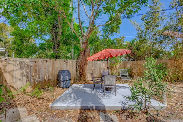 view of patio / terrace featuring a fenced backyard, a deck, and outdoor dining space