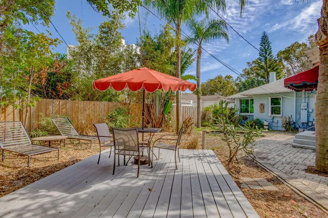 wooden terrace featuring outdoor dining space and fence