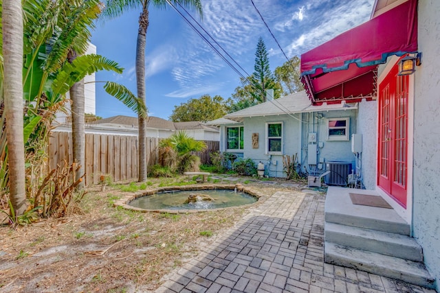 view of yard with cooling unit and fence