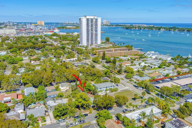 birds eye view of property featuring a water view and a city view