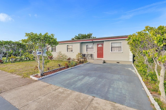 single story home featuring a front yard and stucco siding